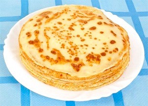 Plate of pancakes on a blue tablecloth