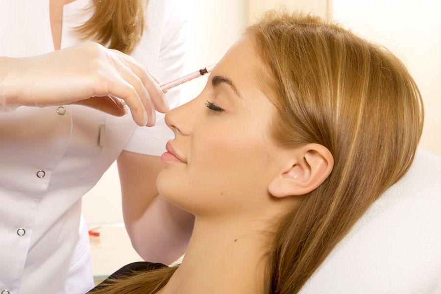 Girl undergo face mesotherapy in a beauty salon