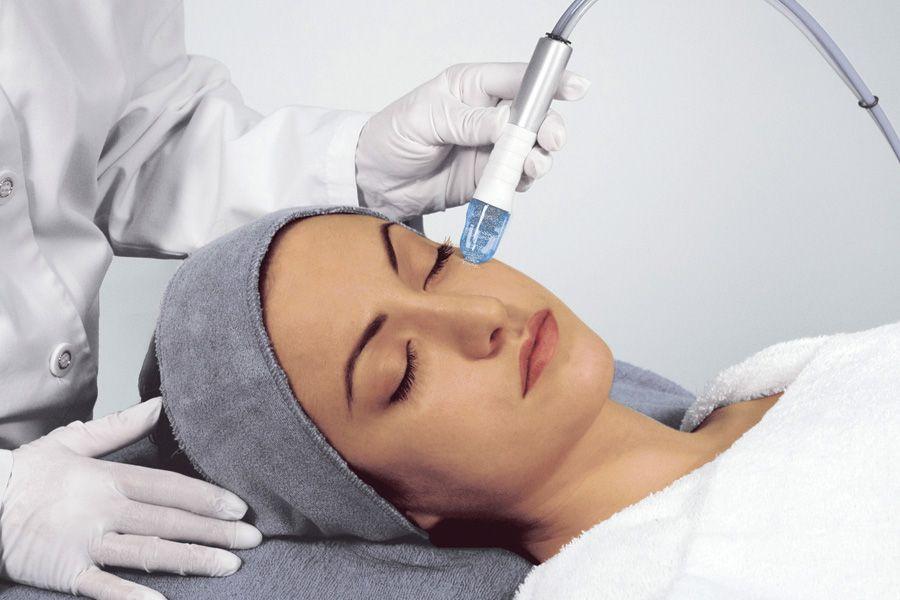 Master makes microdermabrasion procedure in a beauty salon