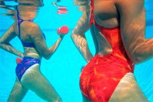 Female bodies underwater in the pool
