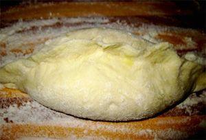 Unbaked pie on a table with flour