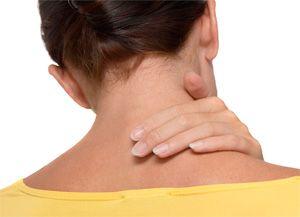 Woman touches a sore neck