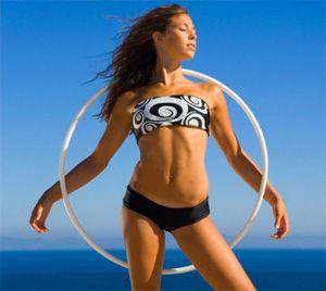 Girl with a hoop for weight loss on a background of the sky