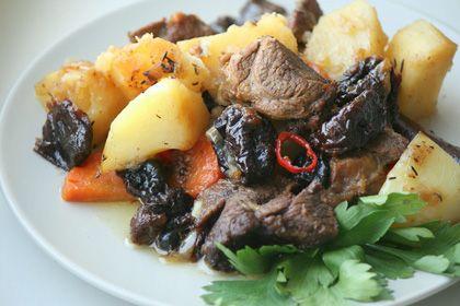 Appetizing lamb cooked in a slow cooker on a plate with potatoes