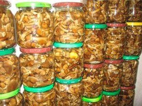 A lot of cans with pickled honey mushrooms