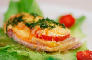 French meat chicken with tomato and cheese on a lettuce leaf