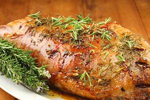 Appetizing mutton ham strewn with herbs