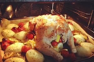 Oven stuffed chicken with potatoes in the oven