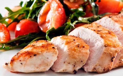 Baked chicken fillet with tomatoes and arugula