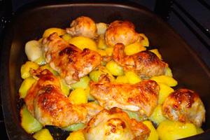 Oven baked appetizing chicken with potatoes