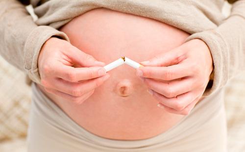 Pregnant girl breaks a cigarette
