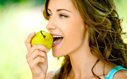 Girl eating pear