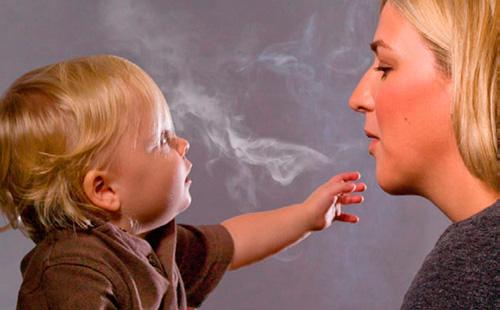 Mom smokes with a child