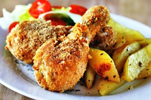 Fried chicken legs breaded with potatoes