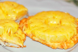 Chicken with pineapple and cheese on a plate