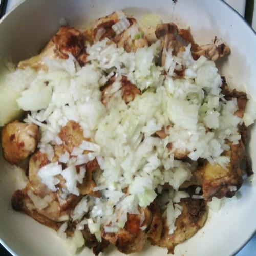 Onions and chicken in a pan