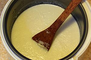 Stir the porridge well with a wooden spoon