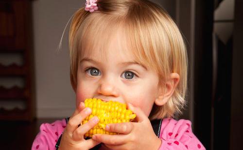 Girl in pink loves corn