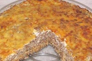 Golden buckwheat casserole with meat, from which someone cut a slice