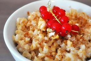 Simple porridge decorated with a sprig of red currant