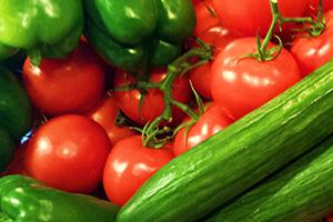 Red tomatoes and green peppers with cucumbers