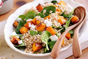 Bright dish with orange pumpkin and green leaves