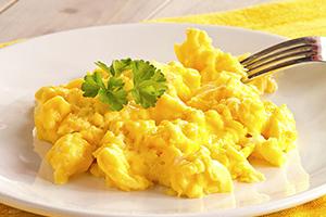 Appetizing bright yellow eggs with a parsley leaf