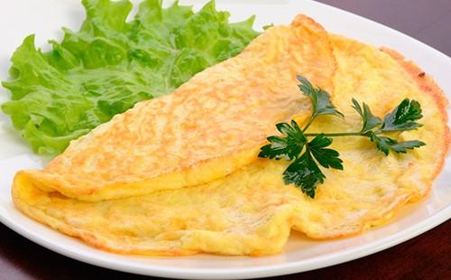 Omelet in a plate with salad and parsley