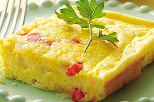 A slice of baked omelet with ham
