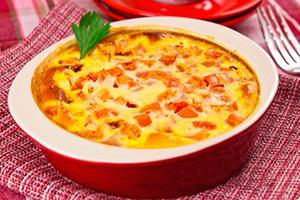 Oven baked omelet with sausage and tomatoes in the oven