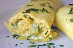 Omelette roll with greens on a plate