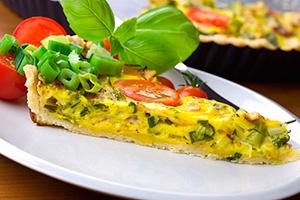 Slice of omelet with vegetables on a plate