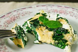Omelet with green spinach leaves