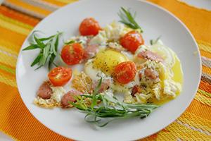 Scrambled eggs with sausage and cherry tomatoes