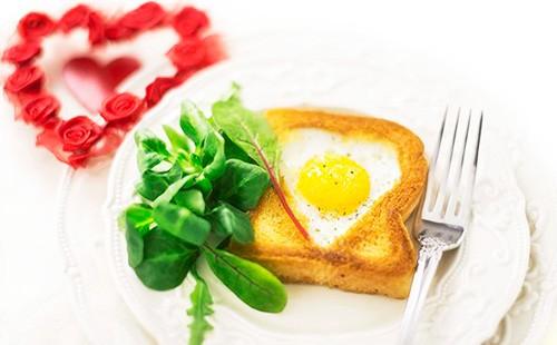 Fried eggs in a bread on a plate with herbs