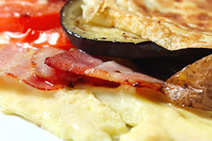 Omelet with bacon and vegetables