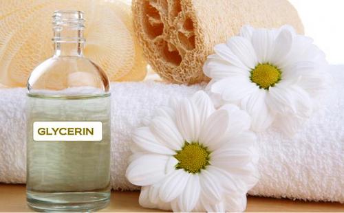 Soft towel, daisy flowers and a bottle of glycerin