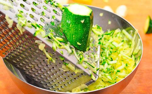 Rubbing zucchini on a coarse grater