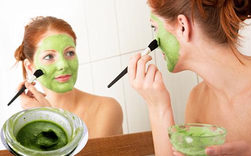 Woman applies green vitamin composition with a brush