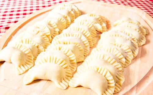 Dumplings folded on a board