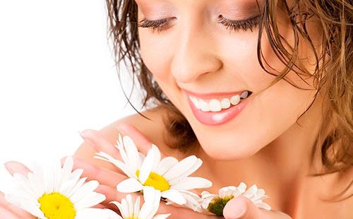 Girl looks at daisies