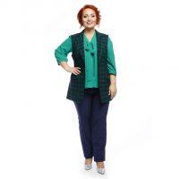 A green blouse and a plaid vest go well with red hair