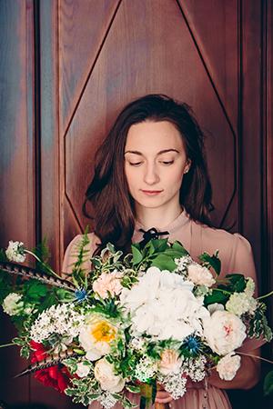 Natalia looks at the lush bouquet in her hands.