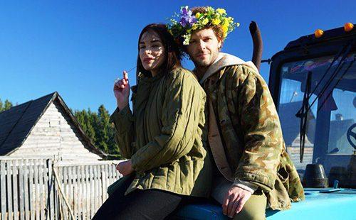 Girl in a padded jacket and a guy in a wreath
