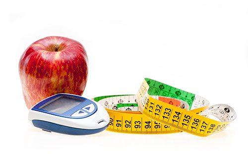 Centimeter, scales and an apple