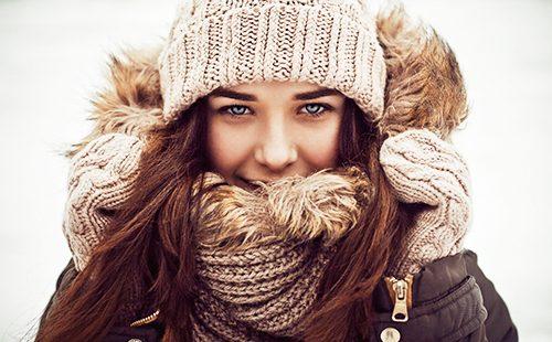 Happy girl in woolen winter clothes