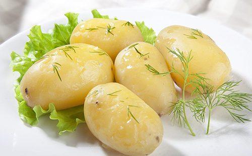 Boiled potatoes with sprigs of greens