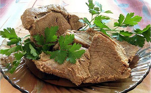Boiled meat is decorated with greens