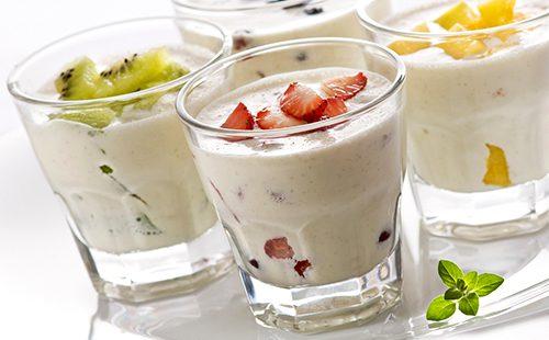 Yogurt in tall glasses with kiwi and strawberries