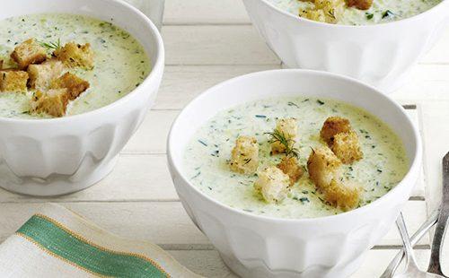 Vegetable soup with croutons in white bowls